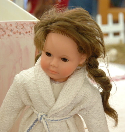 Doll in handwoven bathrobe.