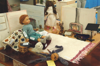 Doll living room with violin, dog, spinning wheel, rug, etc.