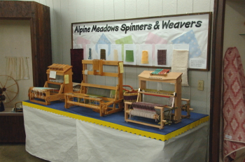 Three table looms demonstrating the weaves used on the doll clothes.